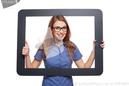 Image of Surprised female peeping out of tablet frame