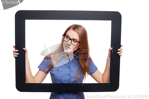 Image of Surprised female peeping out of tablet frame