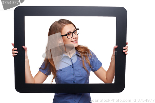 Image of Surprised female peeping out of tablet frame