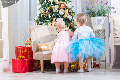 Image of baby girl with christmas present