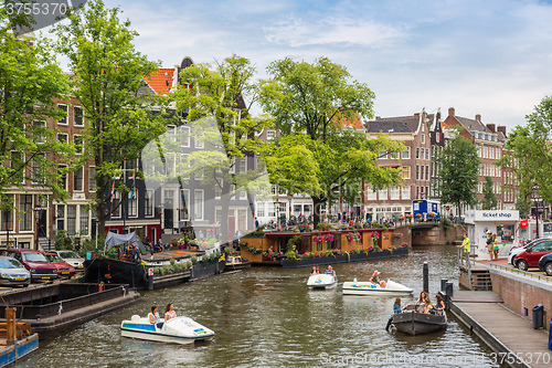 Image of Amsterdam canals and  boats, Holland, Netherlands.