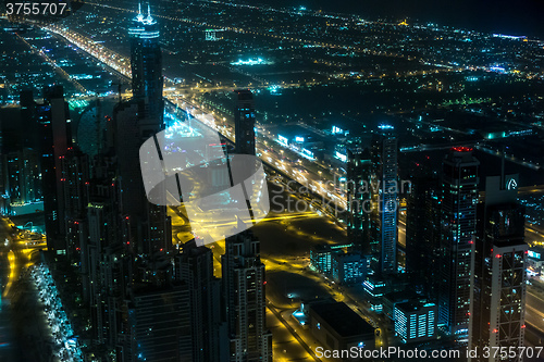 Image of Dubai downtown night scene with city lights,