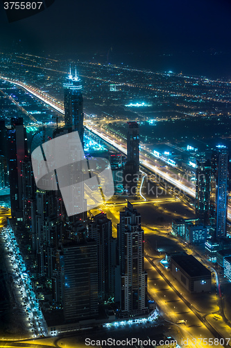 Image of Dubai downtown night scene with city lights,