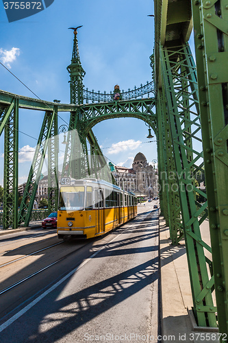 Image of The green Freedom Bridge, with yellow tram, in Budapest,the capi