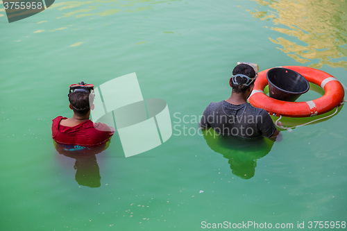 Image of Workers in uniform are cleaning pool