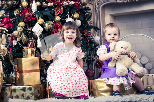 Image of baby girls with christmas present