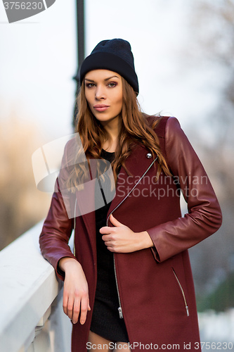 Image of Fashion woman outdoor portrait. Beautiful girl posing on the str