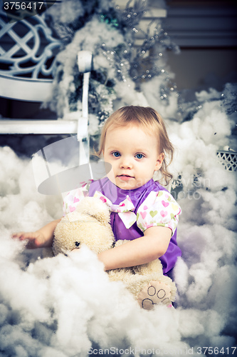 Image of baby girl with christmas present