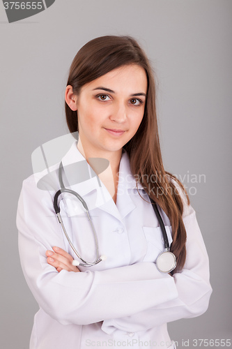 Image of Young and beautiful nurse on a grey