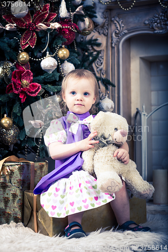 Image of baby girl with christmas present