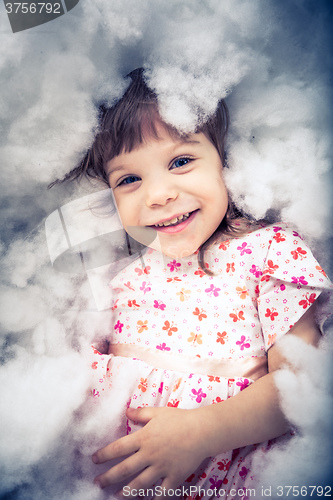 Image of little girl laying on the floor