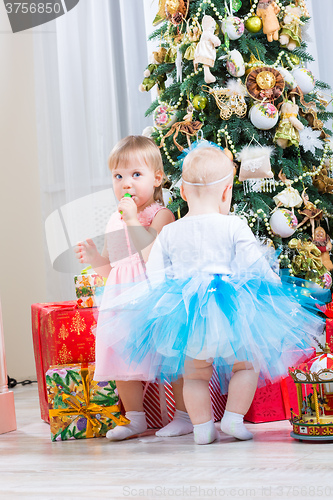 Image of baby girls with christmas present