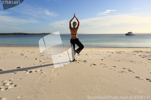 Image of Woman balancing on one leg yoga pose