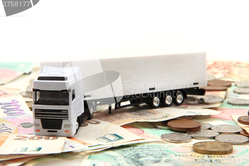 Image of white truck and czech money