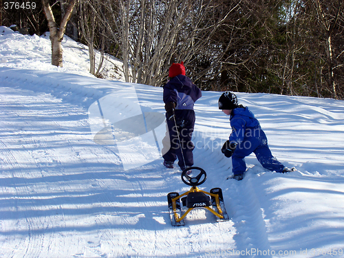 Image of Children pulling ski bob