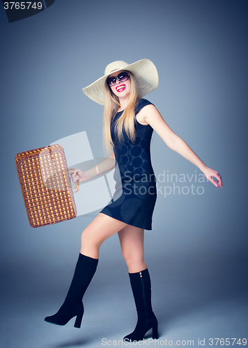 Image of The traveler woman with retro suitcase 