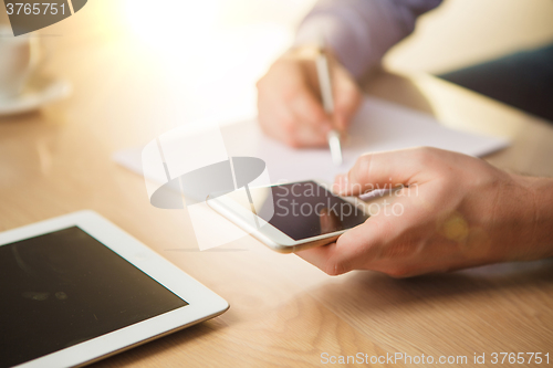 Image of The male hand holding a phone 