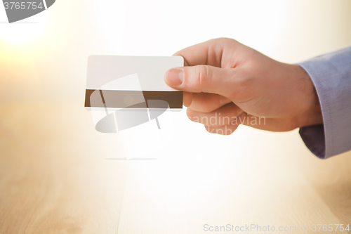 Image of The male hand showing credit card