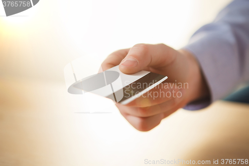 Image of The male hand showing credit card