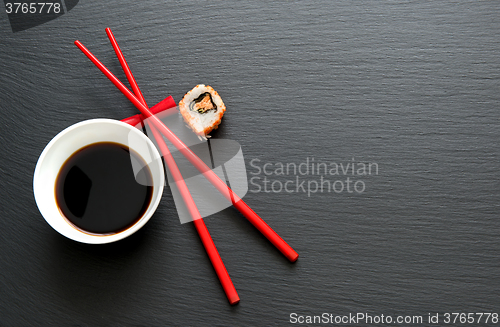 Image of Soy sauce with red chopsticks