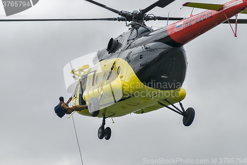 Image of Rescuer is landed from MI-8 helicopter by rope