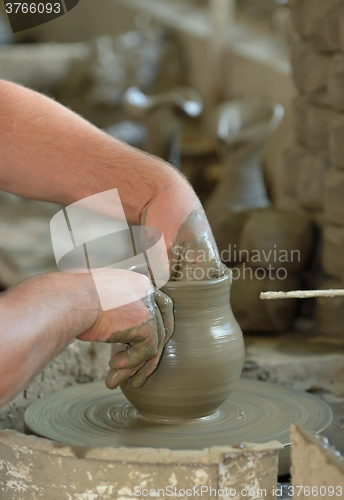 Image of Artisan hands making clay pot