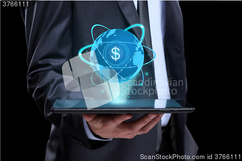 Image of Businessman holding tablet with a projected on-screen icon online trading dollar. business Internet concept.