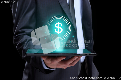 Image of Businessman holding tablet with a projected on-screen icon online trading dollar. business Internet concept.