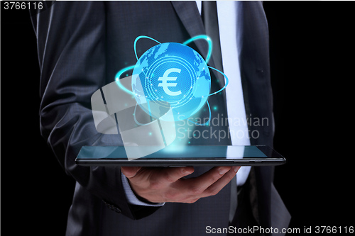 Image of Businessman holding tablet with a projected on-screen icon online trading Euro. business Internet concept.