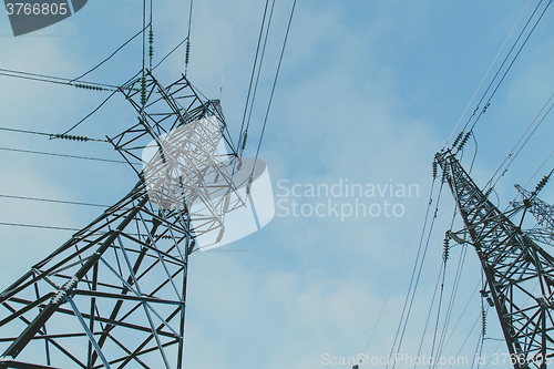 Image of Big frosty power lines among winter.