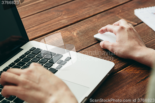 Image of Close-up shot of laptop on old wooden desk