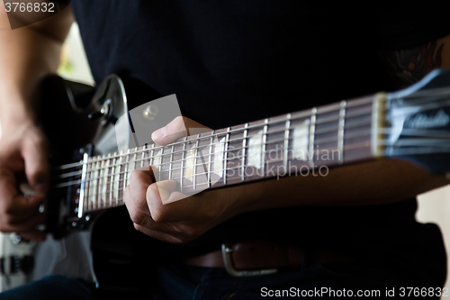 Image of Man playing on guitar