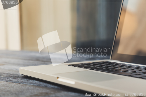 Image of Laptop on modern wooden desk 