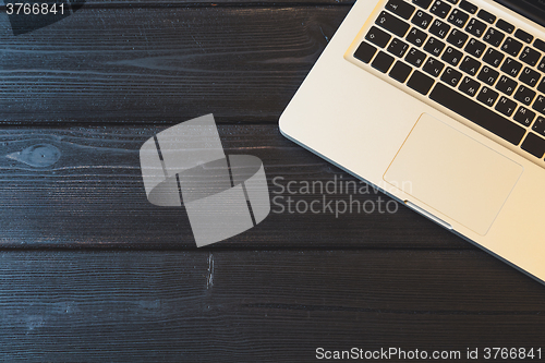 Image of Laptop on modern wooden desk 