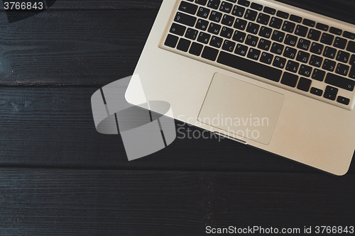 Image of Laptop on modern wooden desk 