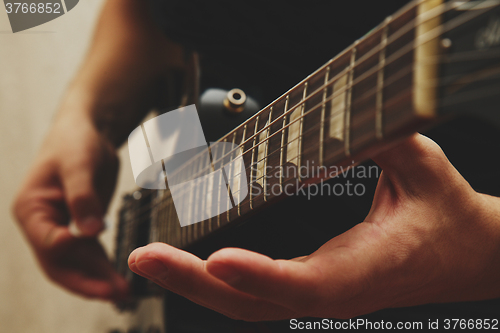 Image of Man playing on guitar