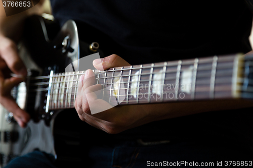 Image of Man playing on guitar