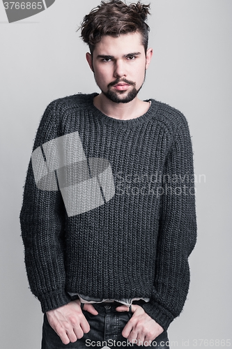 Image of Portrait of a young man in gray pullover