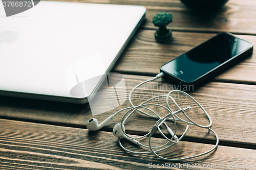 Image of Workplace with open laptop on modern wooden desk 