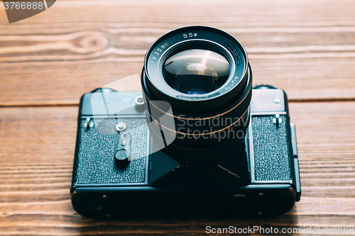 Image of Old camera and on wooden table
