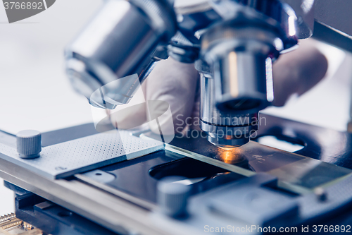 Image of Scientist hands with microscope