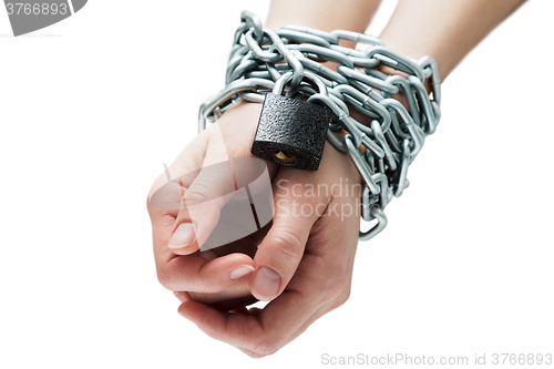 Image of Social theme: hands tied a metal chain on a white background