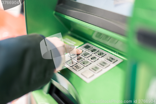 Image of Close-up of hand entering PIN