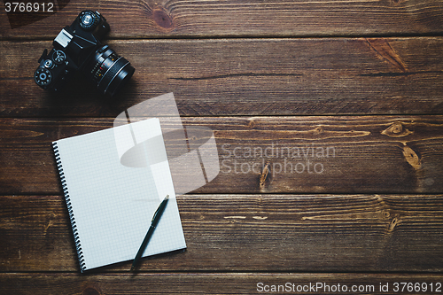 Image of notebook and vintage camera on the desk