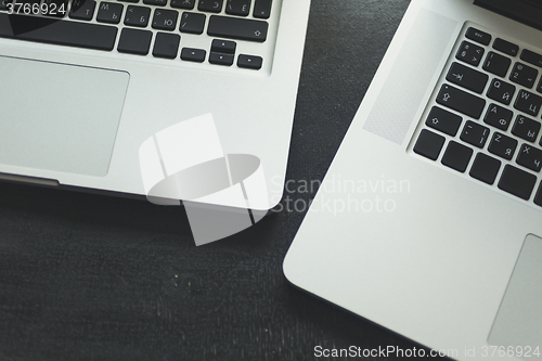 Image of Two laptops on modern wooden desk 