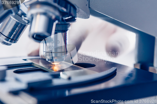 Image of Scientist hands with microscope