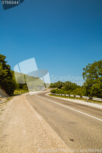 Image of Curved asphalt road in mountains 