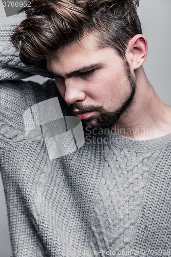 Image of Portrait of a young man in gray pullover