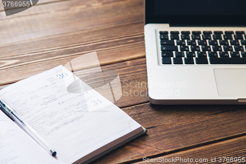 Image of Laptop and diary on the desk