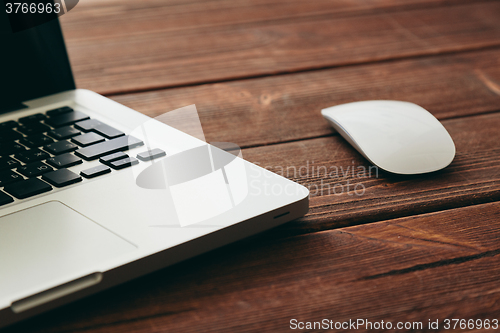 Image of Close-up shot of laptop on old wooden desk